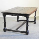 A 19th century oak dining table, with a plank top, on a Gothic carved base,