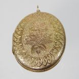 An unmarked locket, of hinged oval shape, finely engraved with a bouquet of flowers,