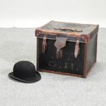 A gentleman's bowler hat, together with a trunk,