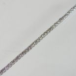 A 9 carat gold diamond tennis bracelet, set with a continuous row of diamonds, approximately 7.