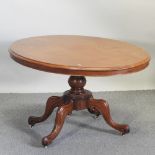 A Victorian walnut tilt top breakfast table, on a splayed base,