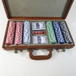 A poker set, in a brown leather case,