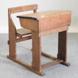 An early 20th century oak school desk,