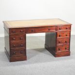 A Victorian mahogany twin pedestal desk, with a tan leather inset writing surface,