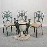 A set of six Fournier, Cariatides iron chairs, with green padded seats,