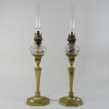 A pair of brass and cut glass oil lamps, with funnels,