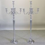 A pair of plated floor standing candelabra,