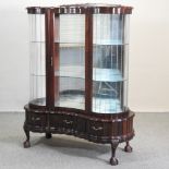 A mid 20th century South African hardwood glazed display cabinet, on cabriole legs,