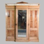 An Edwardian walnut breakfront triple wardrobe,