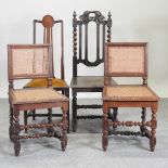 A pair of early 20th century carved oak cane seated side chairs,