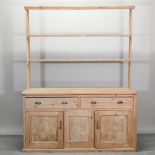 A 19th century pine dresser, with an open plate rack,