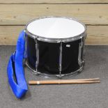 A modern kettle drum, with drumsticks,