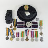 A collection of military items, to include World War I and II medals and belts,