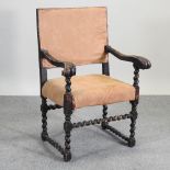A beige upholstered carved open armchair