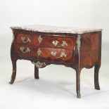 An 18th century French marble top commode, of serpentine shape, with ornate brass mounts,