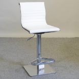 A modern cream leather upholstered bar stool