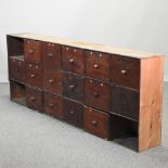 An early 20th century stained pine bank of drawers,