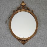 A gilt framed oval wall mirror,