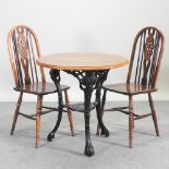 A circular pub table, on a cast iron base, 77cm,