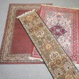 A rug, with all over design, on a red ground, 224 x 161cm, together with a smaller rug,