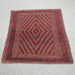 A Turkish woollen rug, with a central diamond, on a red ground,