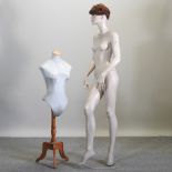 A life size shop mannequin, together with a smaller dressmaker's dummy,