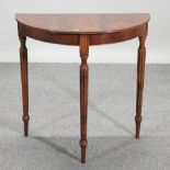 A mahogany half round side table, on fluted legs,