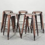 A set of five stacking metal bar stools