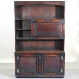 A 19th century and later oak dresser, enclosed by cupboard doors below,