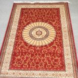 An Aubusson style carpet, with a central medallion, on a red ground,