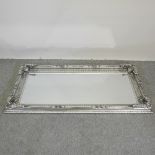 A large ornate silver painted wall mirror,