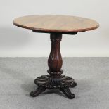 A Victorian carved walnut centre table, with a circular top, on a lappet carved platform base,