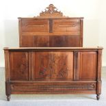 An early 20th century carved walnut double bedstead,