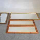 A pair of pine framed dressing mirrors, together with a gilt mirror and another larger,