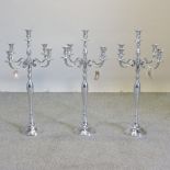 Three plated table candelabra,