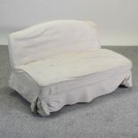 A Victorian cream covered two seater sofa, of small proportions,