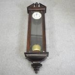 A large 19th century continental stained pine cased wall clock,