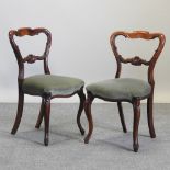 A set of four Victorian carved rosewood balloon back dining chairs,