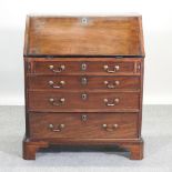 A George III mahogany bureau, on bracket feet,