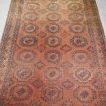 A large woollen carpet, on a brown ground,