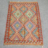 A kelim rug, with diamond pattern, on a cream ground,