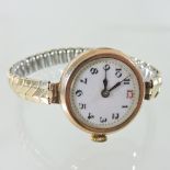 An early 20th century 9 carat gold cased ladies wristwatch, with a white enamel dial,