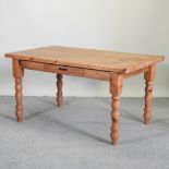 A pine kitchen table, with a single drawer,