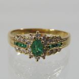 An 18 carat gold emerald and diamond set ring, size Q,