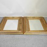 A pair of ornate gilt framed wall mirrors,