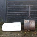 A cast iron garden roller, together with a butler's sink,