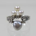 A 14 carat white gold, pearl and diamond cluster ring,