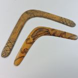 An early 20th century Australian carved wooden boomerang, together with another,