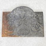 A cast iron fire back, decorated with a coat of arms,