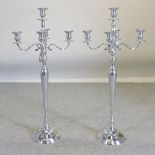 A pair of plated candelabra,